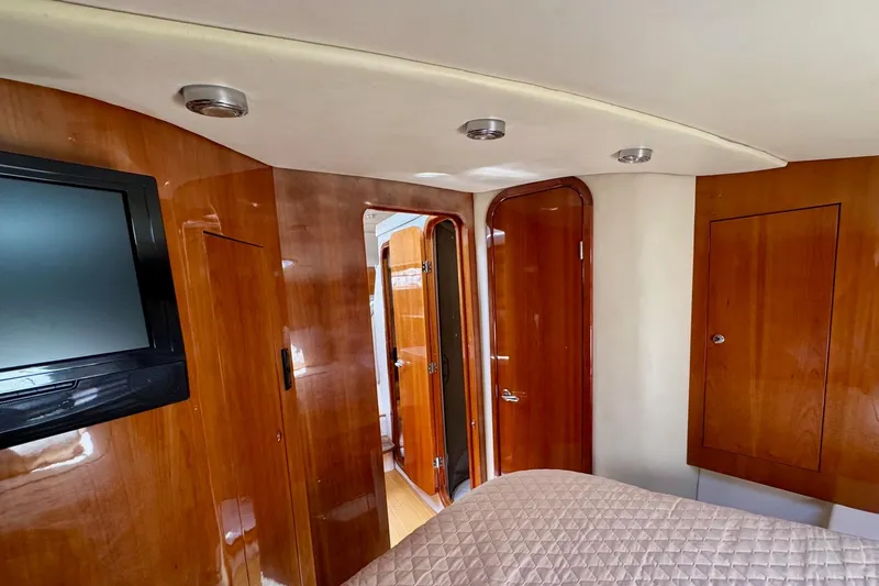 Santa Josefina Yacht Photos Pics Luxurious 2009 Regal 4080 yacht interior with wood paneling and mounted TV.