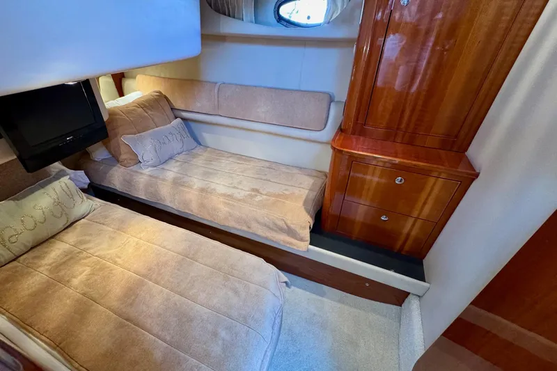 Santa Josefina Yacht Photos Pics Luxurious 2009 Regal 4080 yacht cabin with twin beds and wooden cabinetry.
