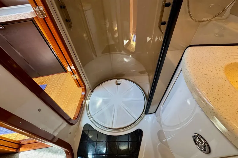 Santa Josefina Yacht Photos Pics Compact bathroom interior of 2009 Regal 4080 yacht, featuring shower and sink.