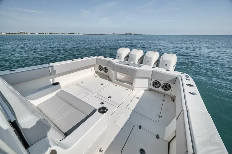  Yacht Photos Pics 2020 SeaVee 39 boat with spacious deck and four powerful outboard engines on open water.