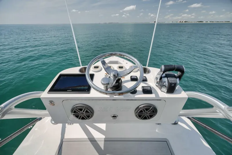  Yacht Photos Pics Helm of 2020 SeaVee 39 boat with steering wheel and controls, overlooking ocean.
