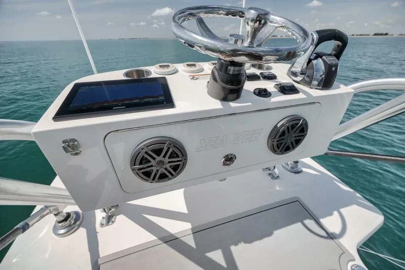  Yacht Photos Pics 2020 SeaVee 39 boat helm with steering wheel, controls, and navigation display on open water.