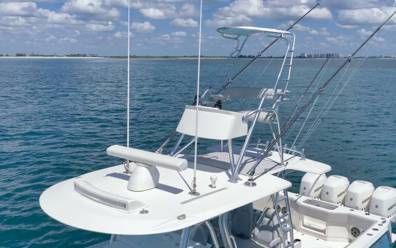  Yacht Photos Pics 2020 SeaVee 39 boat with tower and fishing rods on calm ocean.