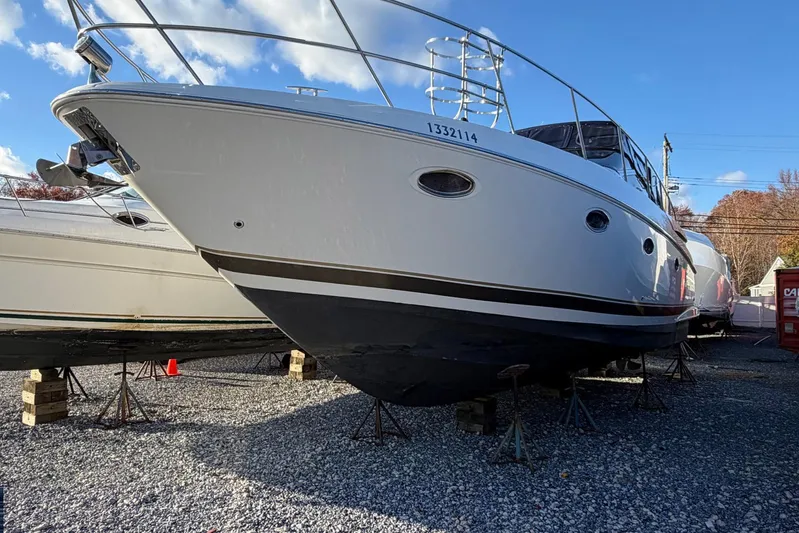 All Too Swell Yacht Photos Pics 2002 Regal Commodore 3860 yacht on stands, under clear blue sky.