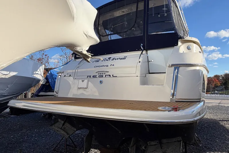 All Too Swell Yacht Photos Pics 2002 Regal Commodore 3860 yacht docked, rear view with clear sky background.