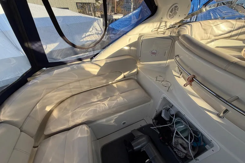 All Too Swell Yacht Photos Pics Interior of 2002 Regal Commodore 3860 yacht with white leather seating and storage area.