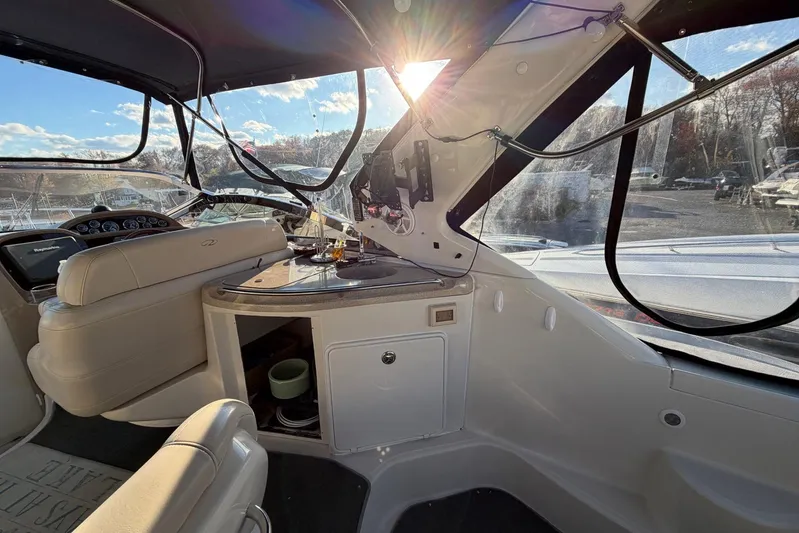 All Too Swell Yacht Photos Pics Interior of a 2002 Regal Commodore 3860 yacht with sunlit dashboard and seating area.
