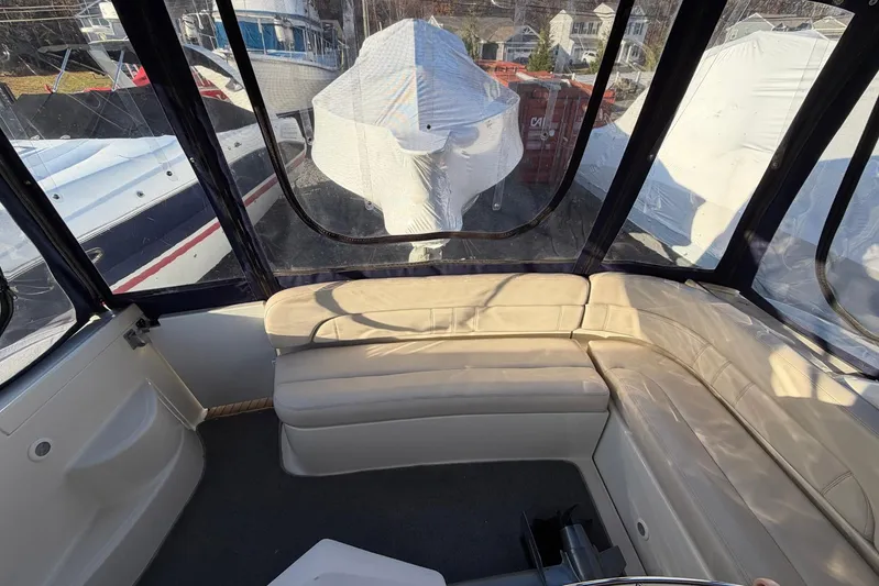 All Too Swell Yacht Photos Pics Interior of a 2002 Regal Commodore 3860 yacht with beige seating and clear windows.