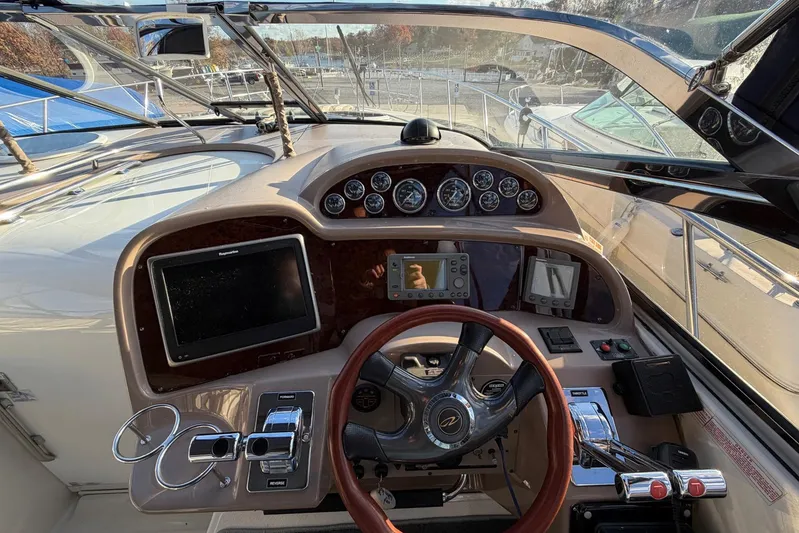 All Too Swell Yacht Photos Pics Cockpit of 2002 Regal Commodore 3860 yacht with steering wheel and navigation instruments.