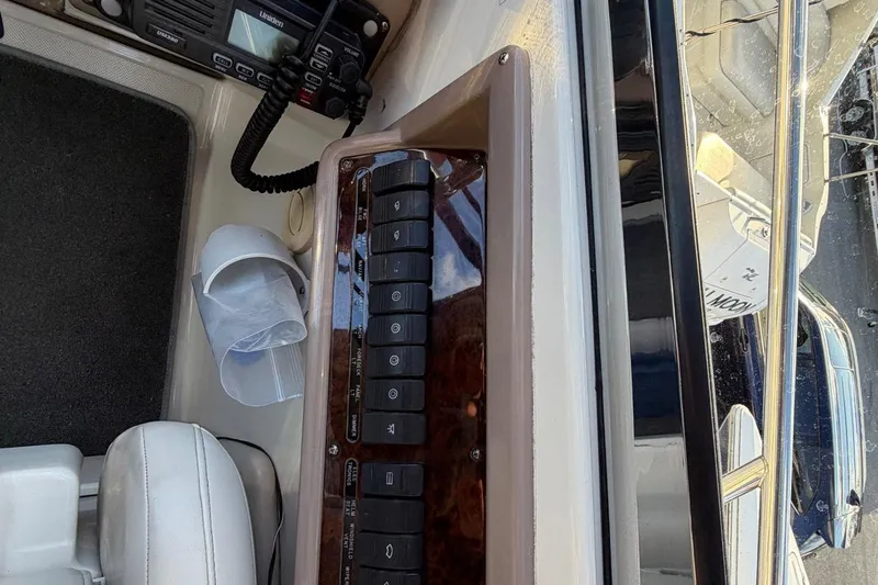 All Too Swell Yacht Photos Pics Control panel of a 2002 Regal Commodore 3860 boat with radio and switches.