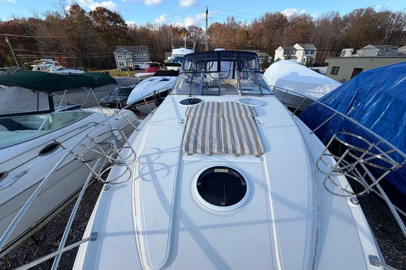 All Too Swell Yacht Photos Pics 2002 Regal Commodore 3860 yacht docked, surrounded by other boats, under a clear sky.