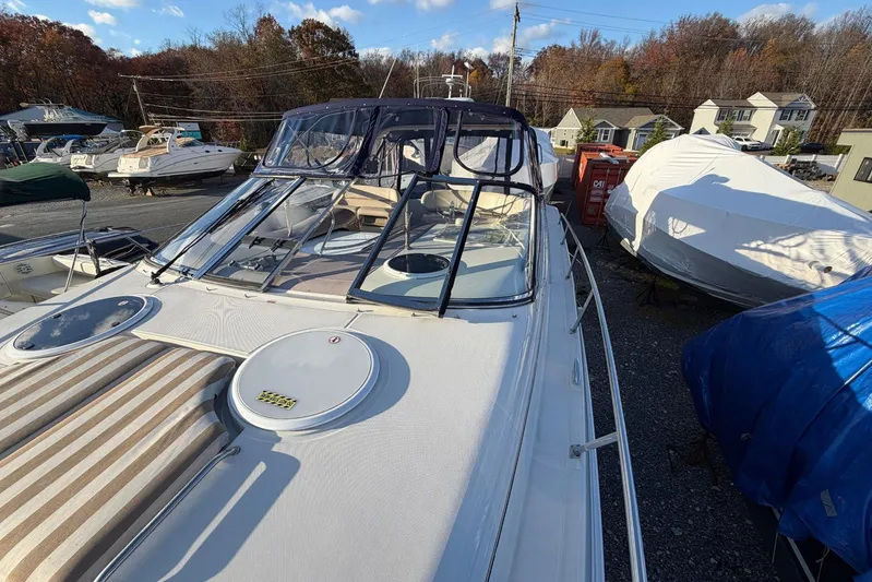 All Too Swell Yacht Photos Pics 2002 Regal Commodore 3860 yacht in storage, surrounded by other boats and autumn trees.