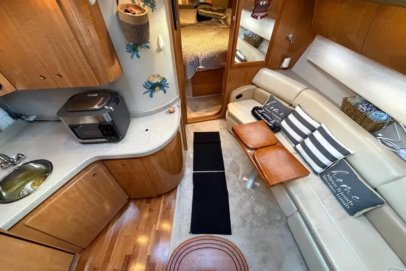 All Too Swell Yacht Photos Pics Luxurious interior of 2002 Regal Commodore 3860 yacht with modern amenities and cozy seating.