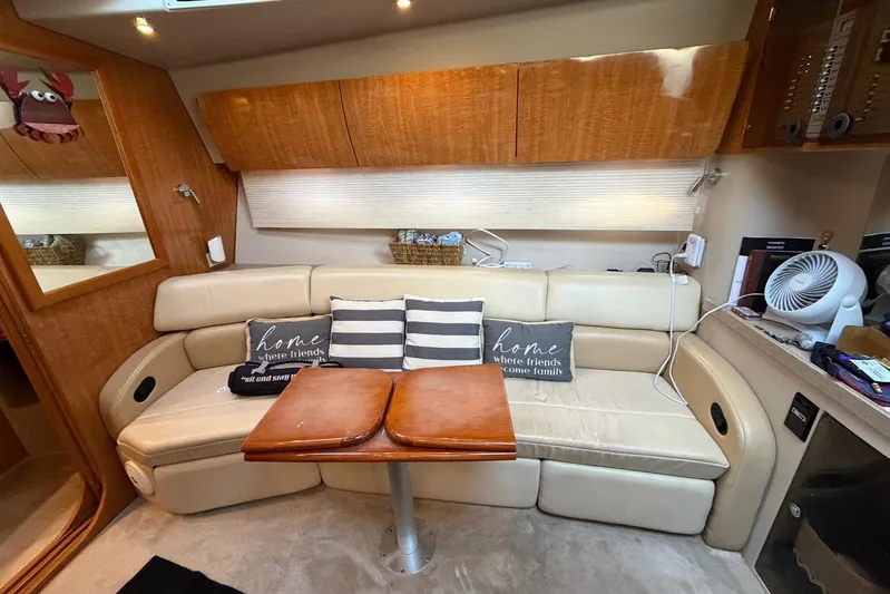 All Too Swell Yacht Photos Pics Interior of 2002 Regal Commodore 3860 yacht with beige seating and wooden accents.