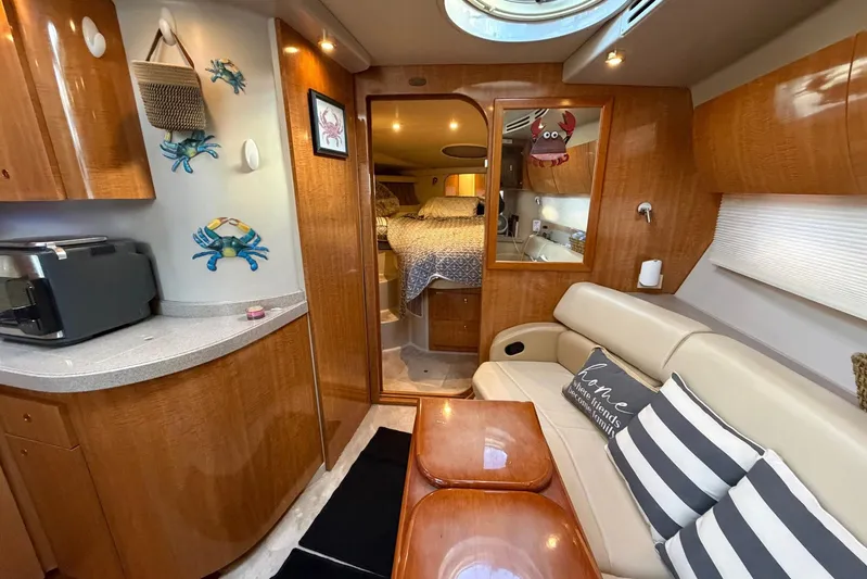 All Too Swell Yacht Photos Pics Interior of 2002 Regal Commodore 3860 yacht with cozy seating and nautical decor.