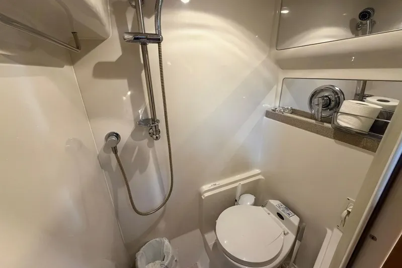 All Too Swell Yacht Photos Pics Compact bathroom in 2002 Regal Commodore 3860 yacht with shower and toilet.