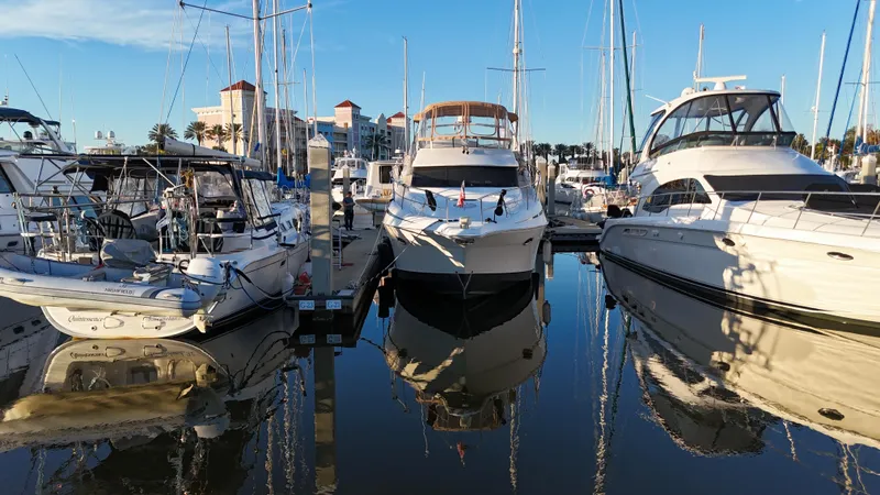  Yacht Photos Pics 2002 Silverton 410 Sport Bridge yacht docked at marina, surrounded by other boats.