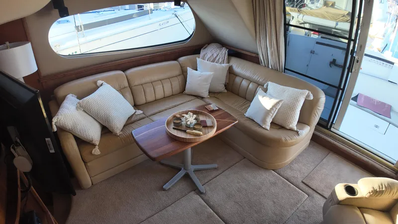  Yacht Photos Pics Luxurious interior of 2002 Silverton 410 Sport Bridge yacht with plush seating and elegant decor.