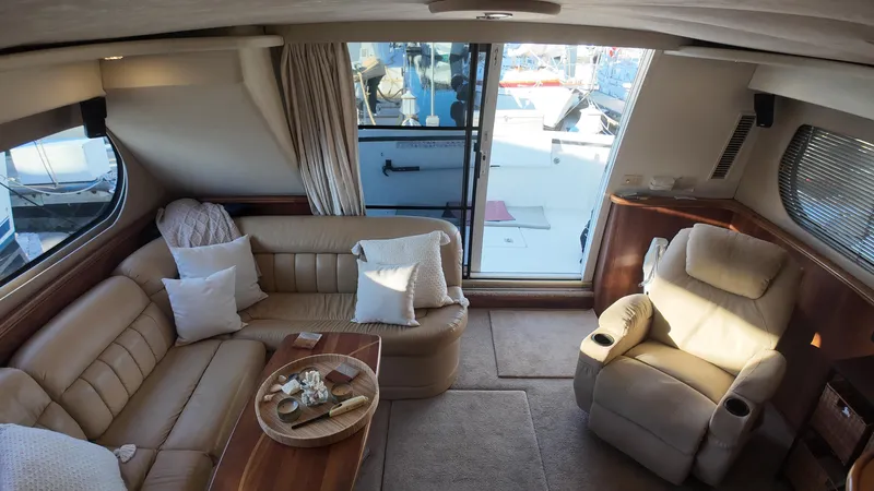  Yacht Photos Pics Luxurious interior of 2002 Silverton 410 Sport Bridge yacht with plush seating and elegant decor.