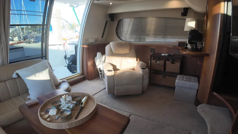  Yacht Photos Pics Luxurious interior of 2002 Silverton 410 Sport Bridge yacht with comfortable seating and elegant decor.