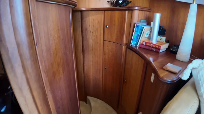  Yacht Photos Pics Luxurious wooden interior of 2002 Silverton 410 Sport Bridge yacht with books and decor.