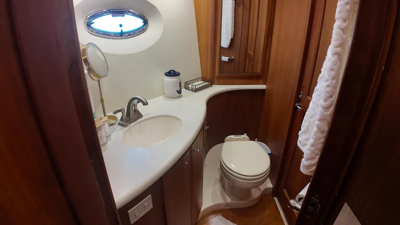  Yacht Photos Pics Luxurious bathroom in 2002 Silverton 410 Sport Bridge yacht with wood accents and modern fixtures.