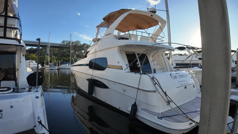  Yacht Photos Pics 2002 Silverton 410 Sport Bridge yacht docked in marina under clear blue sky.