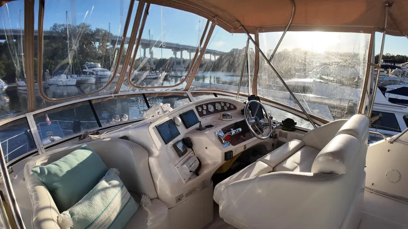  Yacht Photos Pics Interior view of 2002 Silverton 410 Sport Bridge yacht cockpit with steering wheel and controls.