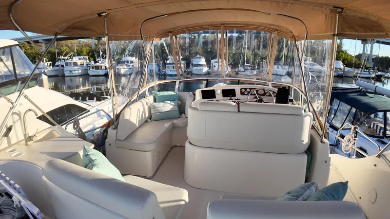  Yacht Photos Pics 2002 Silverton 410 Sport Bridge yacht interior with plush seating and marina view.