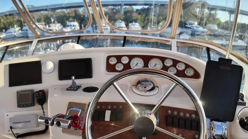  Yacht Photos Pics 2002 Silverton 410 Sport Bridge helm with steering wheel and navigation instruments.