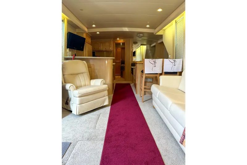  Yacht Photos Pics Luxurious interior of 2012 Bluewater 5200 Custom Series Yacht with plush seating and modern amenities.