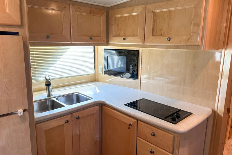  Yacht Photos Pics Modern kitchen in 2012 Bluewater 5200 Custom Series Yacht with wood cabinets and dual sink.