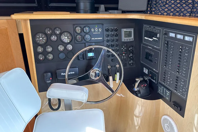  Yacht Photos Pics Cockpit of 2012 Bluewater 5200 Custom Series Yacht with steering wheel and control panel.