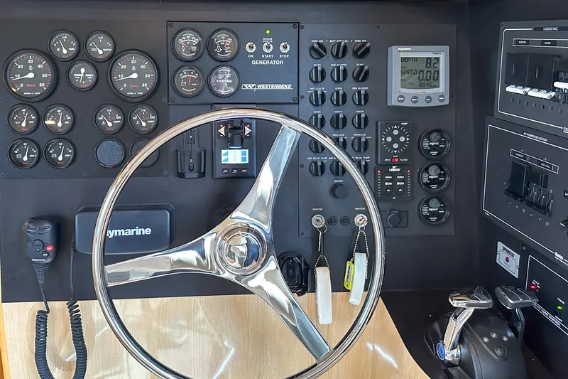  Yacht Photos Pics Control panel of 2012 Bluewater 5200 Custom Series Yacht with steering wheel and gauges.