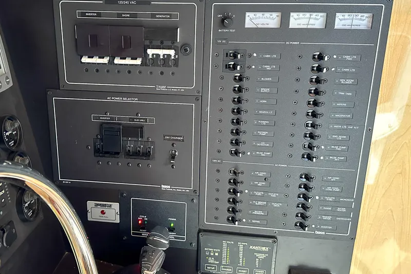  Yacht Photos Pics Control panel of a 2012 Bluewater 5200 Custom Series Yacht, featuring various switches and gauges.