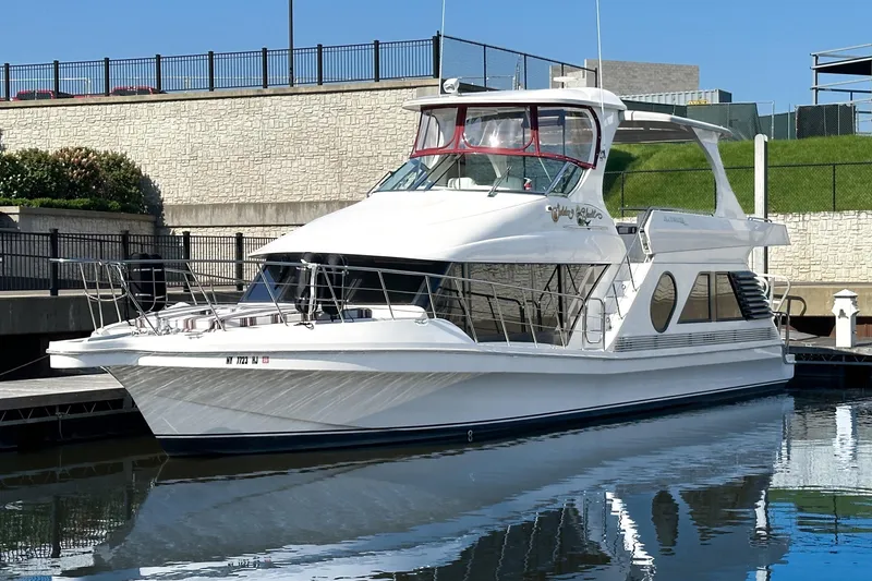  Yacht Photos Pics 2012 Bluewater 5200 Custom Series Yacht docked in a marina, reflecting on calm water.