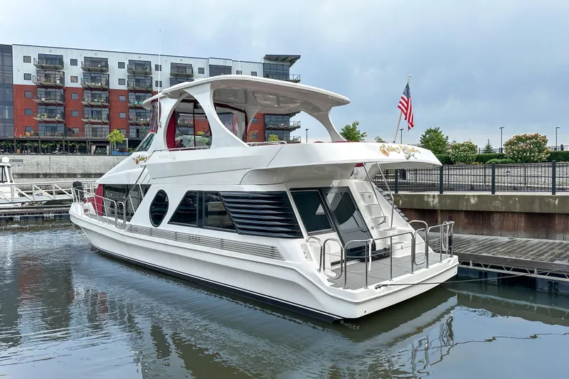  Yacht Photos Pics Luxury 2012 Bluewater 5200 yacht docked in a marina with modern buildings.