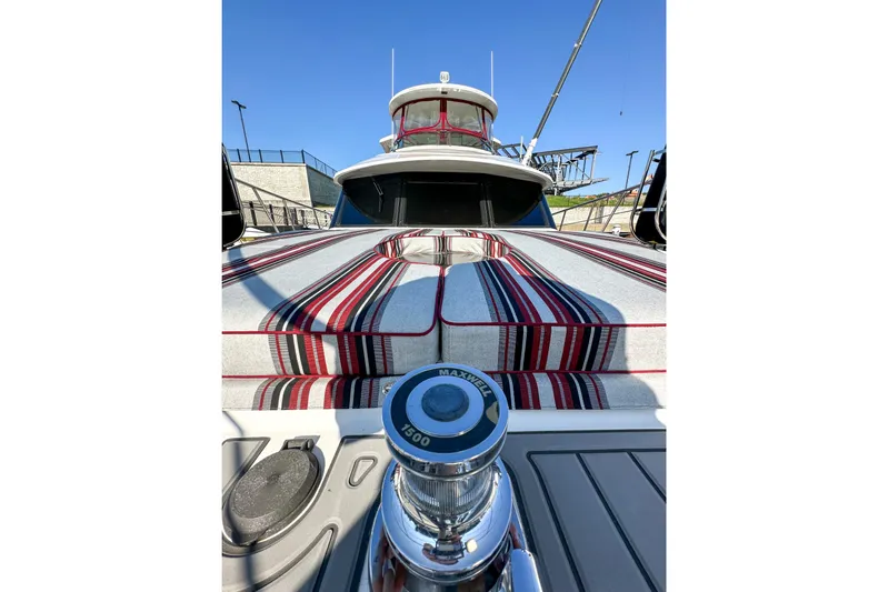  Yacht Photos Pics 2012 Bluewater 5200 yacht with striped deck cushions and winch, under clear blue sky.