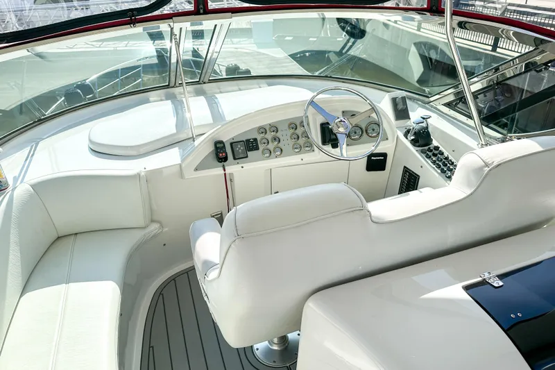  Yacht Photos Pics Luxurious 2012 Bluewater 5200 yacht cockpit with white seating and modern controls.