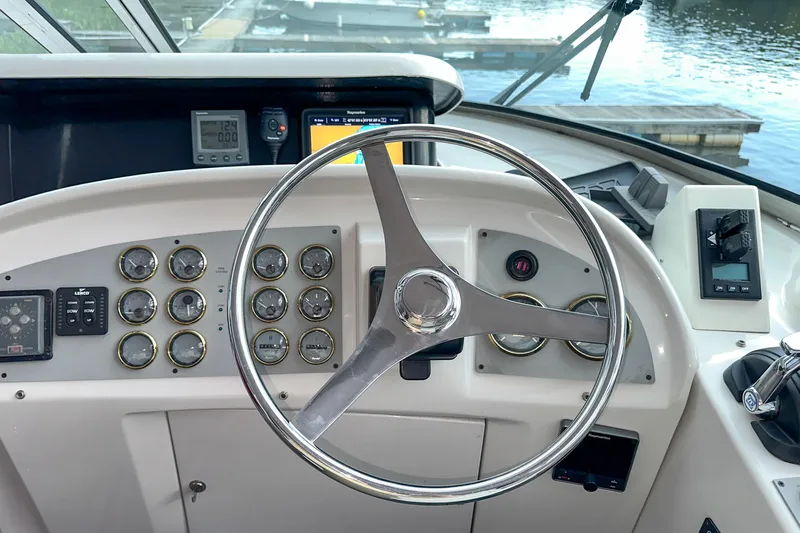  Yacht Photos Pics Steering wheel and dashboard of 2012 Bluewater 5200 boat, featuring multiple gauges and controls.