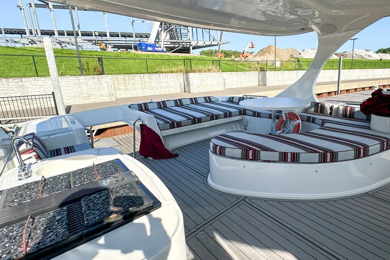  Yacht Photos Pics Luxurious 2012 Bluewater 5200 yacht deck with striped seating and modern amenities.