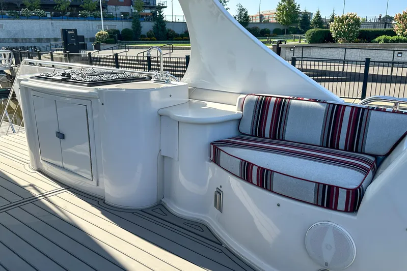  Yacht Photos Pics Luxury Bluewater 5200 yacht deck with striped seating and outdoor kitchen, 2012 model.
