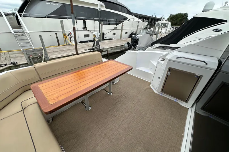 Sexy B'yacht-ch Yacht Photos Pics 2013 Cruisers Yachts 45 Cantius deck with seating and wooden table.