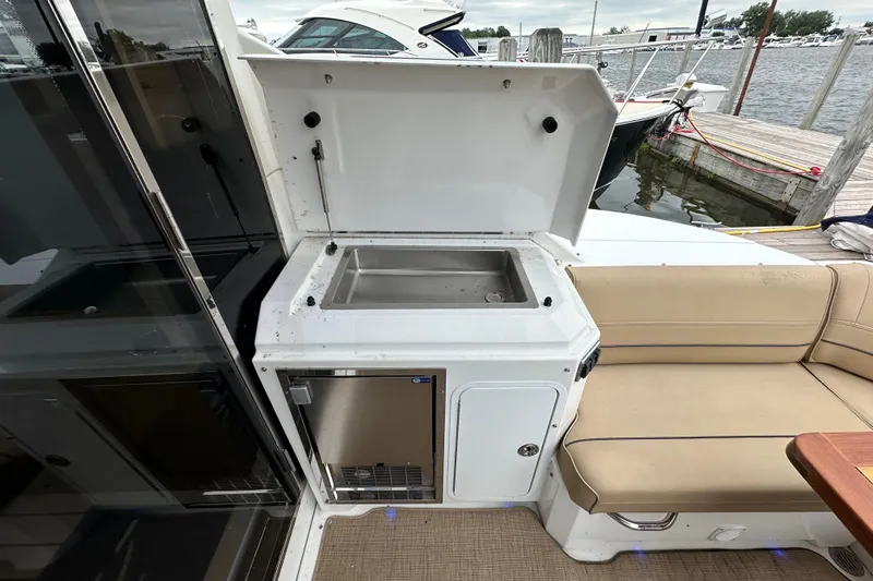 Sexy B'yacht-ch Yacht Photos Pics Outdoor kitchenette on 2013 Cruisers Yachts 45 Cantius, featuring sink and seating area.
