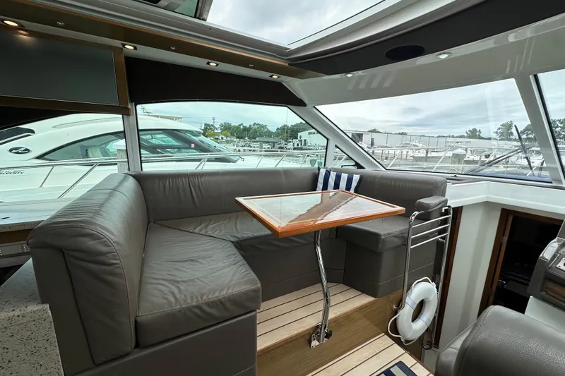 Sexy B'yacht-ch Yacht Photos Pics Luxurious 2013 Cruisers Yachts 45 Cantius interior with leather seating and wooden table.