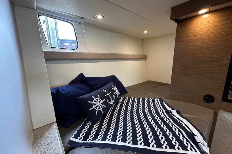 Sexy B'yacht-ch Yacht Photos Pics Luxurious cabin interior of 2013 Cruisers Yachts 45 Cantius with nautical-themed bedding.