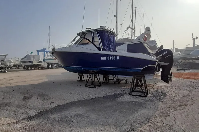  Yacht Photos Pics 2009 Fountain 33 Sportfish Cruiser on stands in a boatyard, with Mercury outboard.