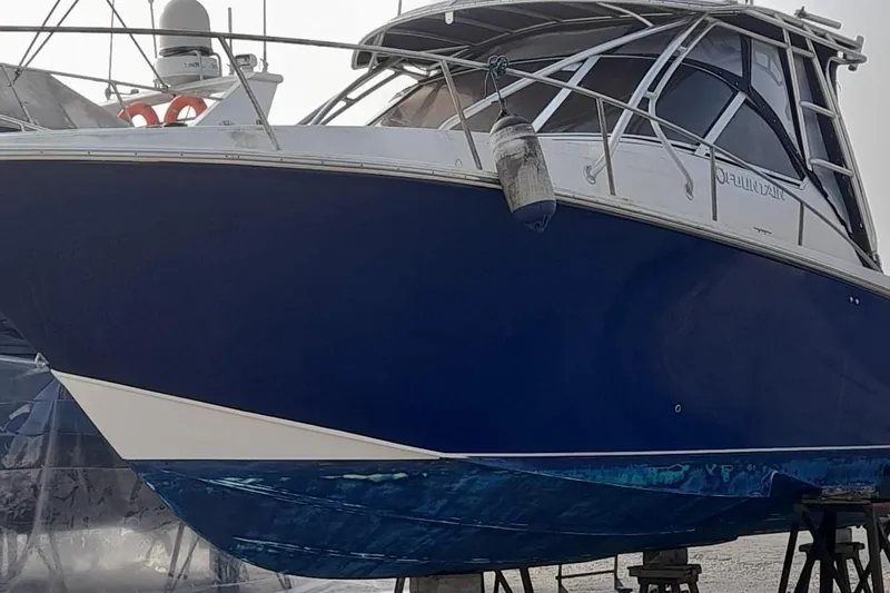  Yacht Photos Pics 2009 Fountain 33 Sportfish Cruiser with blue hull on dry dock.