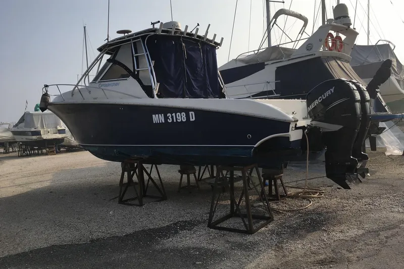  Yacht Photos Pics 2009 Fountain 33 Sportfish Cruiser on stands, featuring twin Mercury outboard engines.