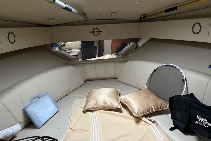 Yacht Photos Pics 2009 Fountain 33 Sportfish Cruiser cabin with beige seating and pillows.
